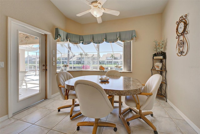 tiled dining space with ceiling fan