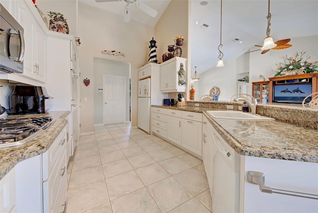 kitchen with appliances with stainless steel finishes, ceiling fan, sink, pendant lighting, and white cabinets