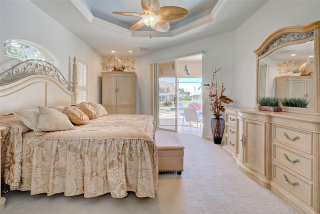 bedroom with access to exterior, ceiling fan, crown molding, a tray ceiling, and light carpet