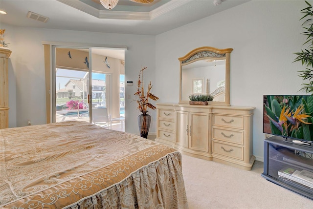 bedroom featuring access to exterior, light colored carpet, a raised ceiling, and ornamental molding