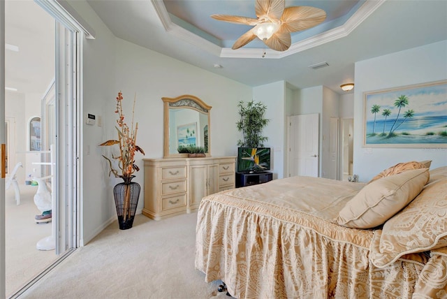 carpeted bedroom featuring a tray ceiling, ceiling fan, and ornamental molding