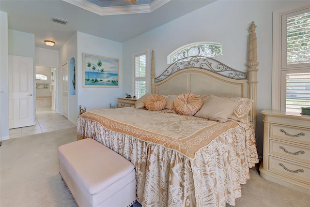 bedroom with light carpet, a raised ceiling, multiple windows, and ornamental molding