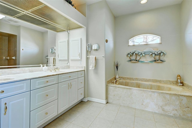 bathroom featuring tile patterned floors, a bathtub, and vanity