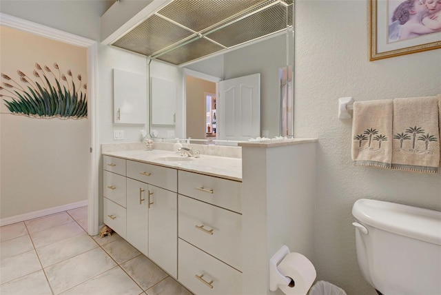 bathroom with tile patterned flooring, vanity, and toilet