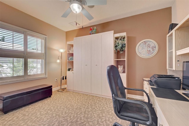 carpeted office with ceiling fan