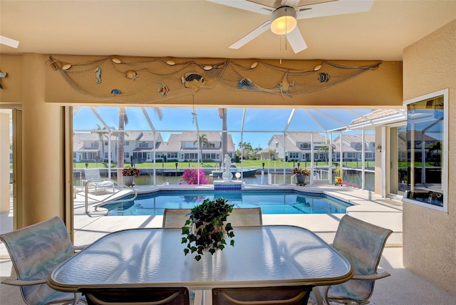 view of swimming pool with a water view and ceiling fan