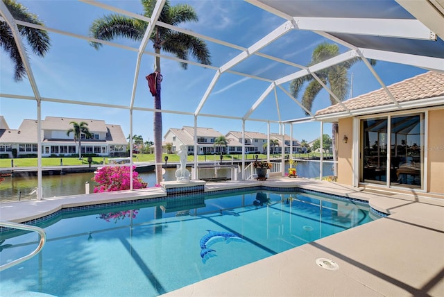 view of swimming pool featuring a patio, a water view, and a lanai