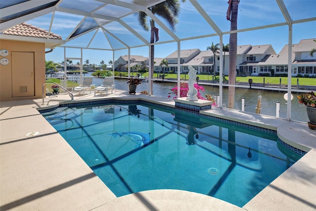 view of swimming pool featuring a dock, a patio, a water view, and glass enclosure