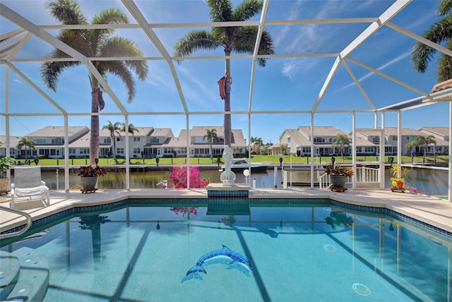 view of pool with a water view, a patio area, and a lanai