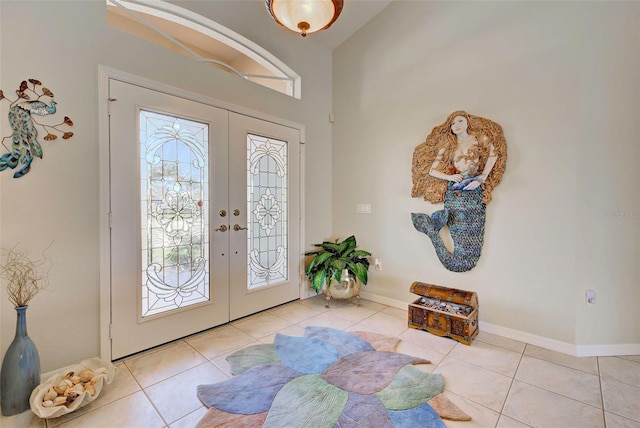 foyer with french doors, a healthy amount of sunlight, and light tile patterned flooring