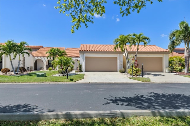 mediterranean / spanish house featuring a garage