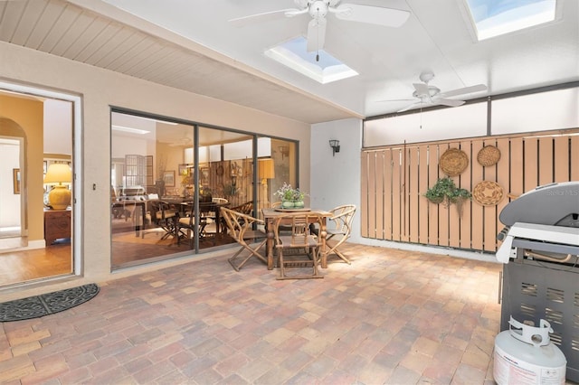 sunroom with ceiling fan and a skylight