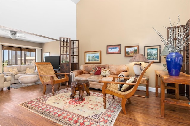 living room featuring wood-type flooring and ceiling fan