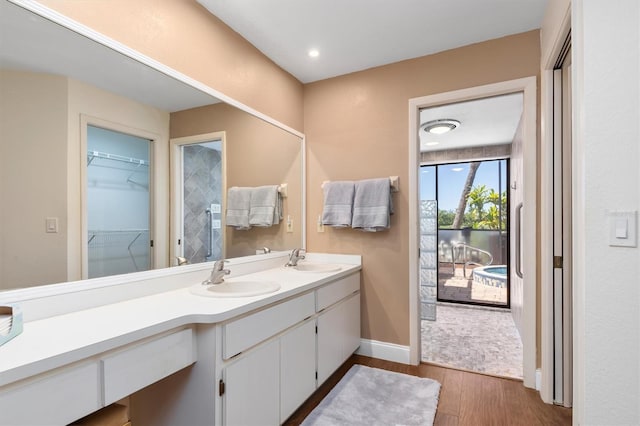 bathroom with double vanity and wood-type flooring