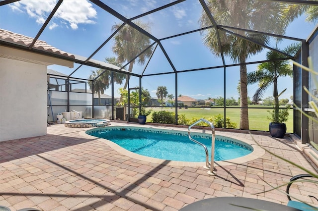 view of swimming pool featuring a yard, an in ground hot tub, a patio, and a lanai