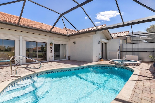 view of pool with an in ground hot tub, glass enclosure, and a patio