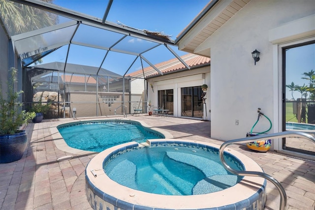 view of swimming pool with an in ground hot tub, a lanai, and a patio area