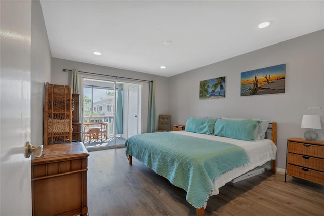 bedroom featuring wood-type flooring and access to outside