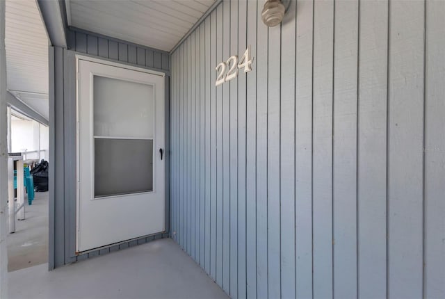 doorway to property featuring board and batten siding