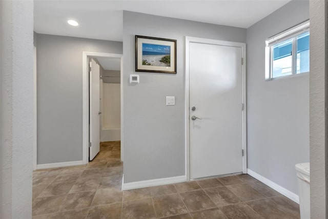 tiled foyer featuring baseboards