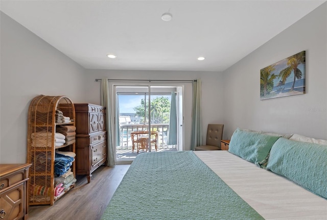 bedroom featuring access to exterior, recessed lighting, and light wood-type flooring