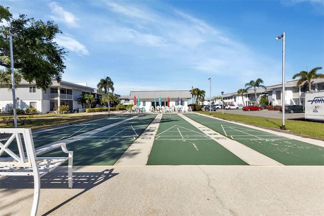 view of home's community featuring shuffleboard