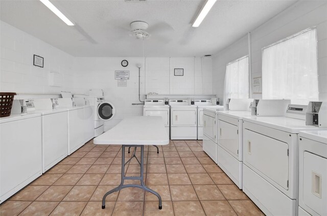 laundry area with separate washer and dryer, a textured ceiling, light tile patterned floors, and ceiling fan