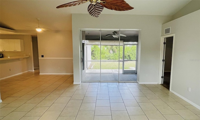 empty room with light tile floors and ceiling fan