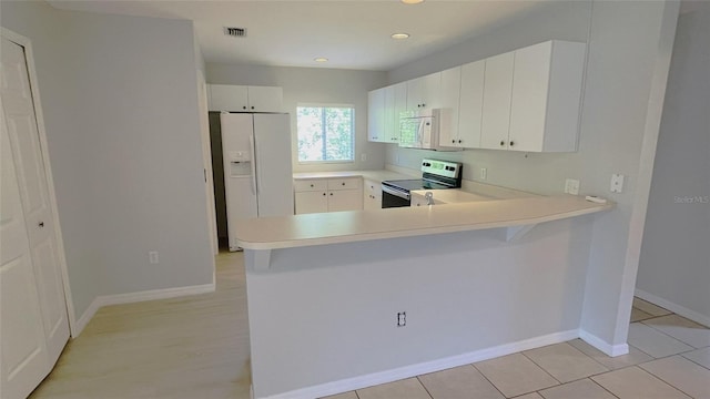 kitchen with white appliances, white cabinets, kitchen peninsula, and light tile floors