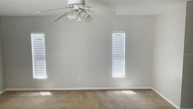 unfurnished room with carpet, plenty of natural light, and ceiling fan