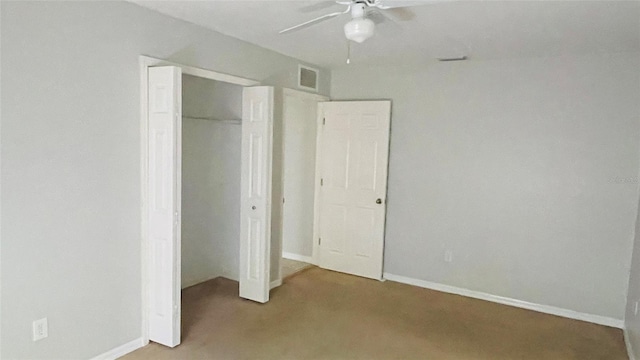 unfurnished bedroom with a closet, light carpet, and ceiling fan