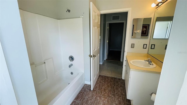 bathroom featuring vanity with extensive cabinet space, tile flooring, and bathing tub / shower combination