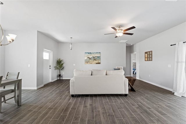 living room featuring dark hardwood / wood-style flooring and ceiling fan with notable chandelier