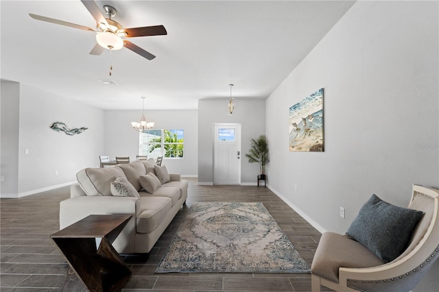 living room featuring ceiling fan with notable chandelier