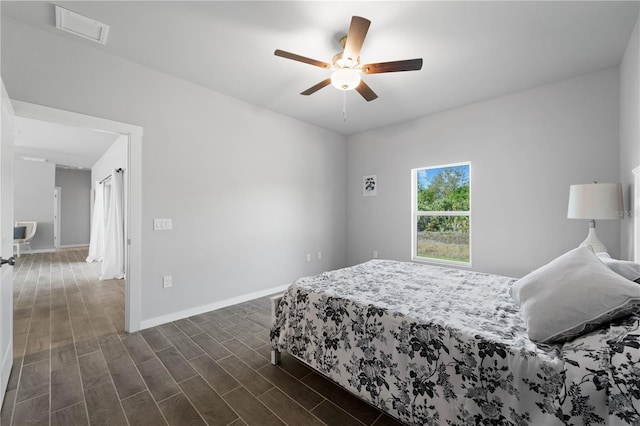 bedroom with ceiling fan and dark hardwood / wood-style flooring