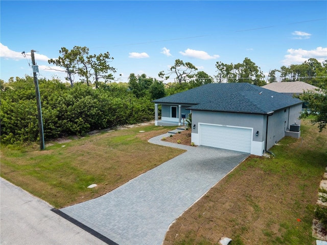 view of front of house featuring a front yard and a garage