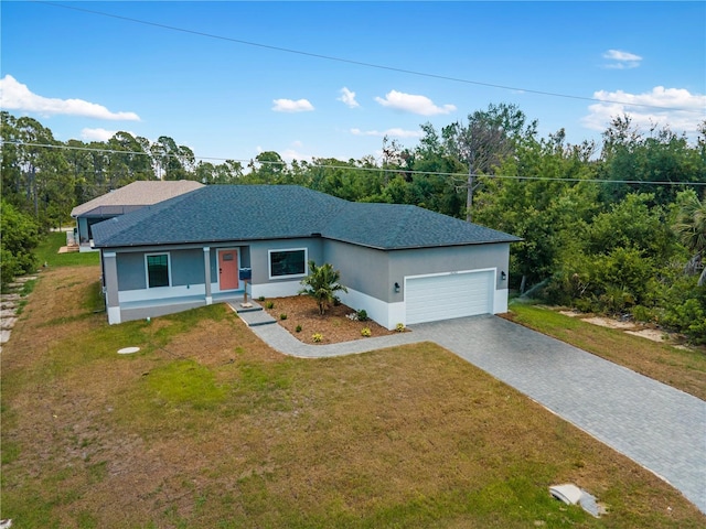 single story home featuring a garage and a front lawn