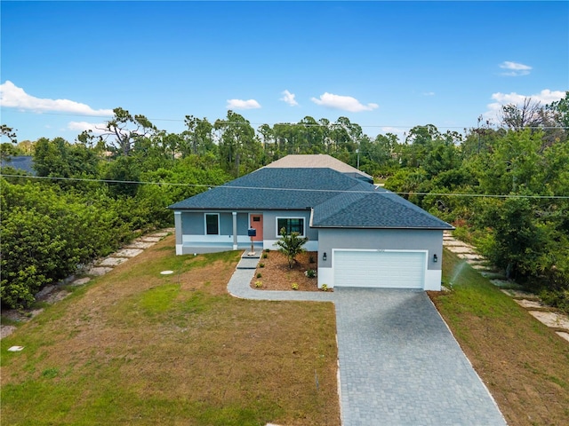 view of front of home with a garage and a front lawn