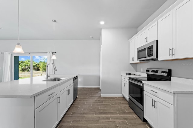 kitchen with white cabinets, appliances with stainless steel finishes, hanging light fixtures, and sink