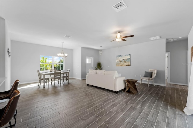 living room featuring ceiling fan with notable chandelier