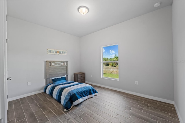 bedroom with dark hardwood / wood-style floors