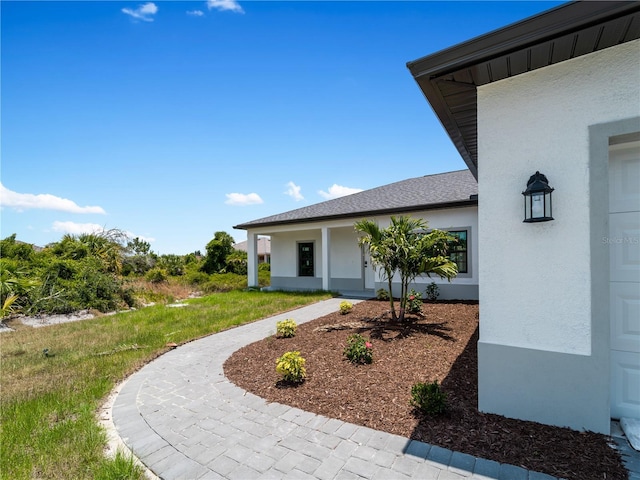 entrance to property with a yard