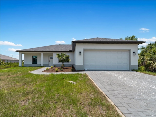 ranch-style house featuring a garage and a front lawn