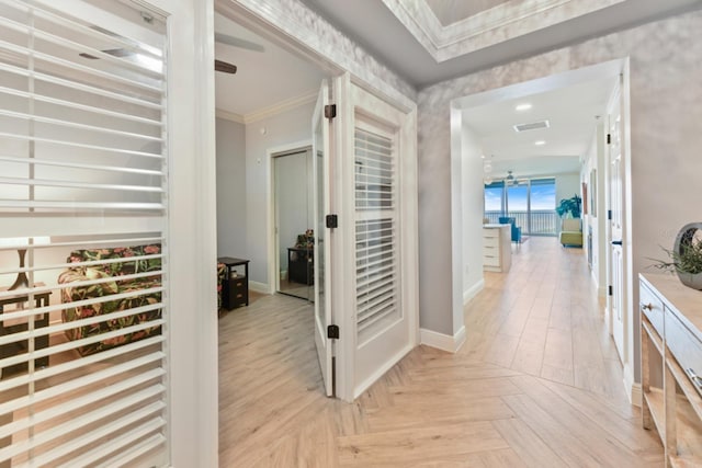 hallway with light parquet flooring and ornamental molding