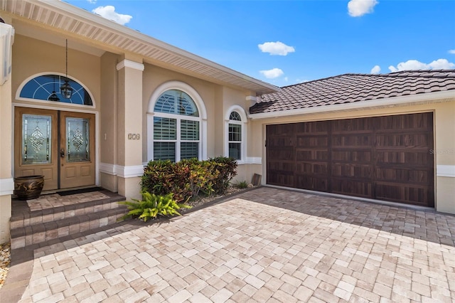 view of front of home with french doors and a garage