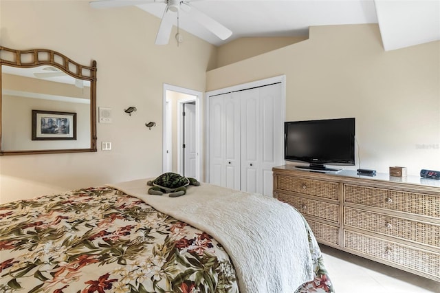 tiled bedroom with vaulted ceiling, a closet, and ceiling fan