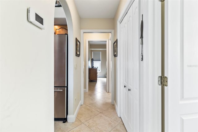 corridor featuring light tile floors