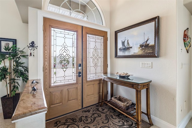 foyer entrance with french doors and a healthy amount of sunlight