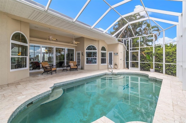 view of swimming pool with ceiling fan, a patio, and a lanai