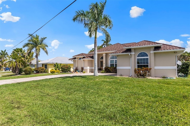 mediterranean / spanish home with a front yard